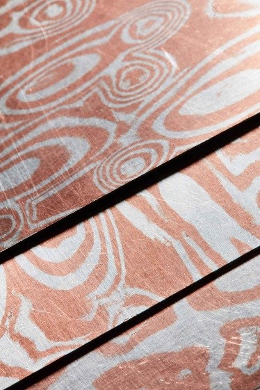 Decorative metallic sheet produced by fusing several layers of sterling silver and copper.